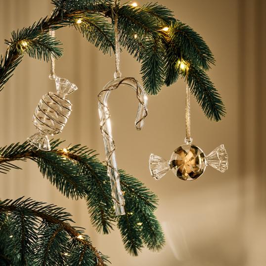 Candy-shaped christmas ornaments hanging on a christmas tree