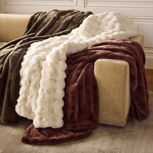 Faux fur blankets draped over couch