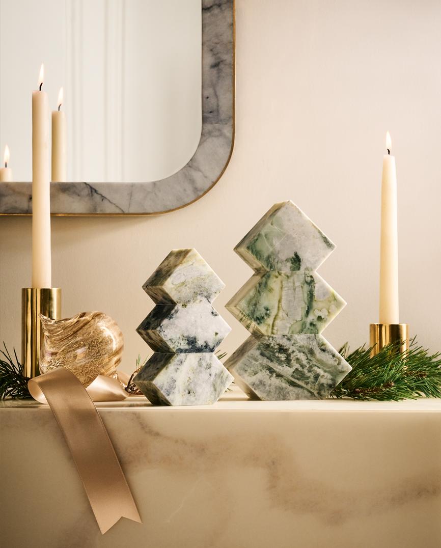 Christmas decor and candles on fireplace mantle