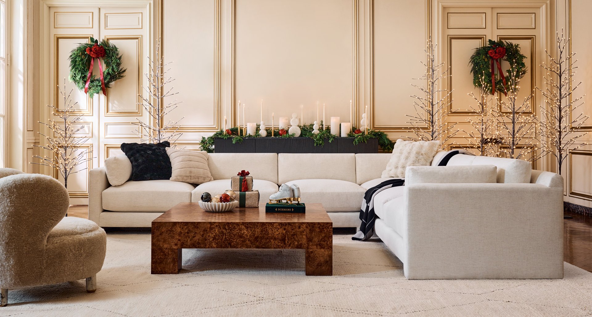 Modern Living Room decorated with Christmas decor and wreaths, White modern Sectional and modern coffee table