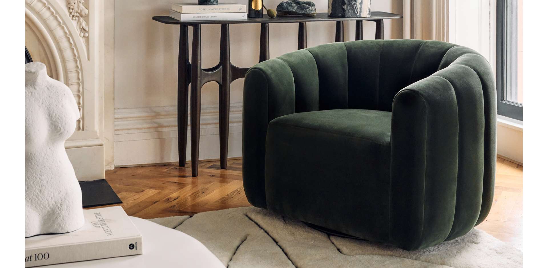 Large and spacious room with brown couch and white accent chair with a rug between them