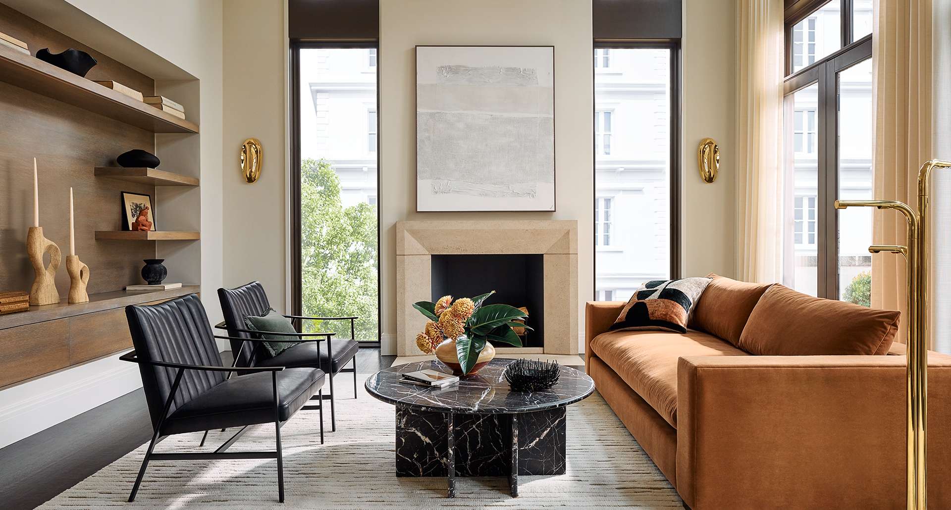 Large and spacious room with brown couch and white accent chair with a rug between them