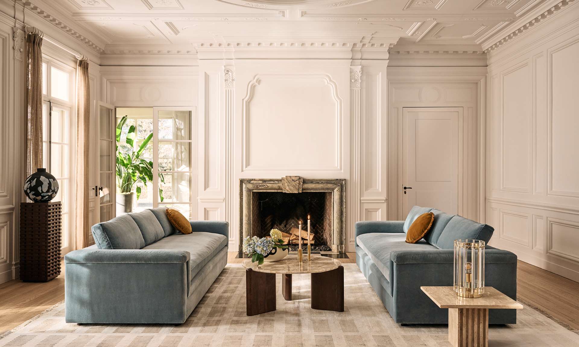 Large and spacious room with brown couch and white accent chair with a rug between them