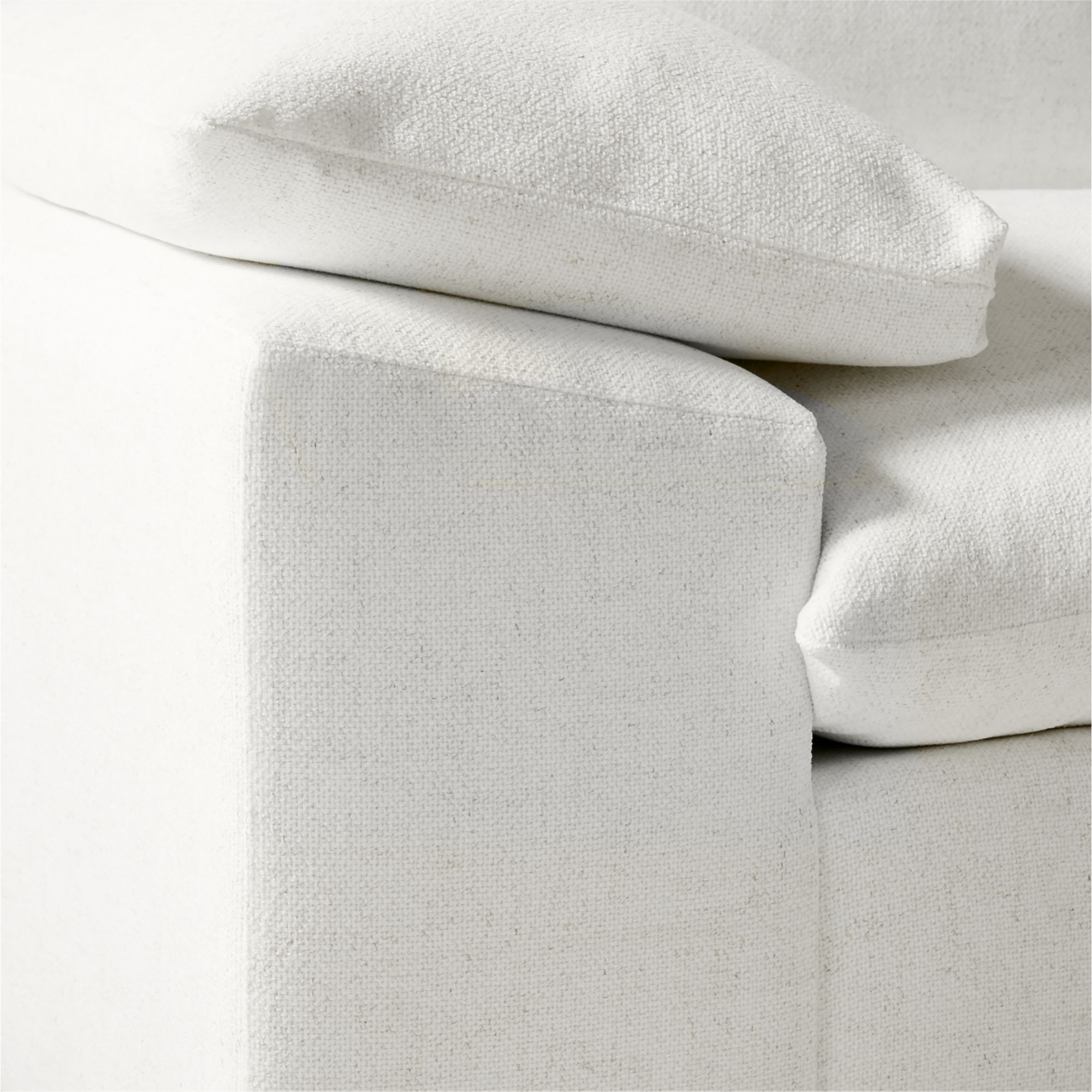 Close-up texture of the white performance fabric on the sleeper sofa.