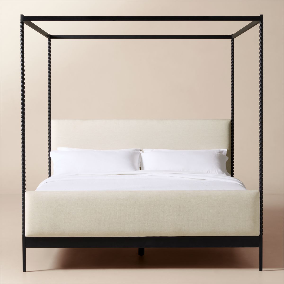 Hand-forged steel canopy bed with warm white upholstery
