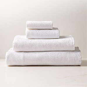 https://cb2.scene7.com/is/image/CB2/ArmelaWhtWaffleCollectionFHF23/$web_plp_card_mobile$/230327152019/armela-organic-cotton-white-waffle-bath-towels.jpg