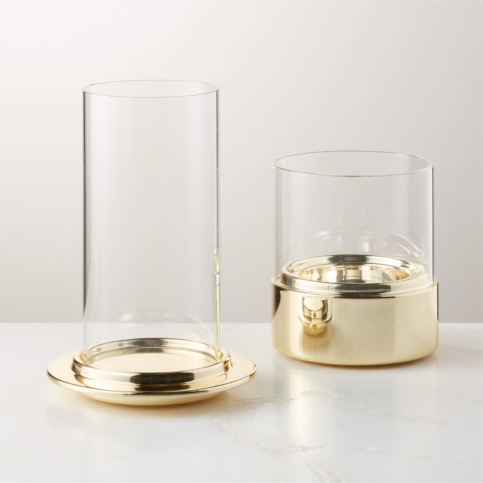 Alta and Bassa Champagne Brass Hurricane Candle Holders CB2