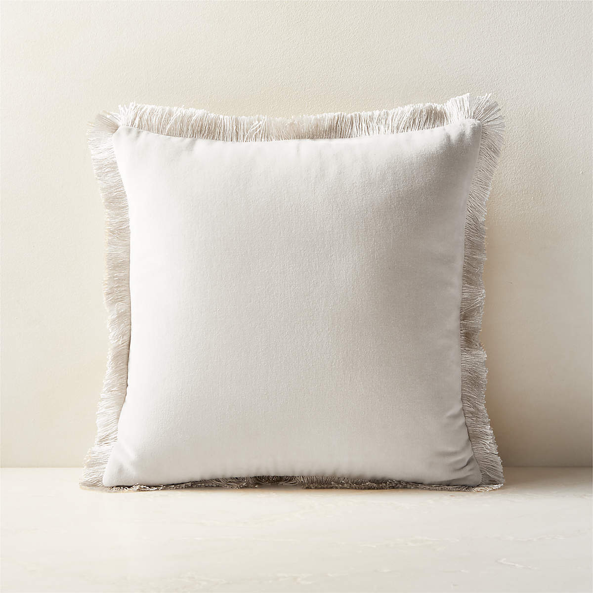 https://cb2.scene7.com/is/image/CB2/BettieIvoryDnAltPllw16x16SHF23/$web_pdp_main_carousel_md$/230613125947/bettie-warm-white-velvet-throw-pillow-16.jpg