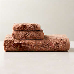 https://cb2.scene7.com/is/image/CB2/BrooksDstyRsOrgCtnBthTwlBndSHF23/$web_plp_card_mobile$/230512115019/brooks-ribbed-organic-cotton-dusty-rose-bath-towel-set.jpg