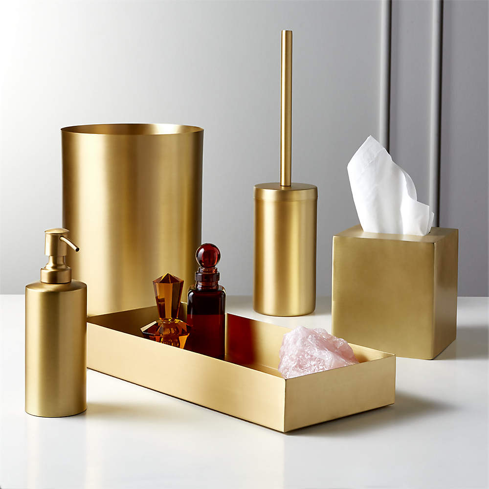 Gold and black contemporary bathroom features a brass waste basket