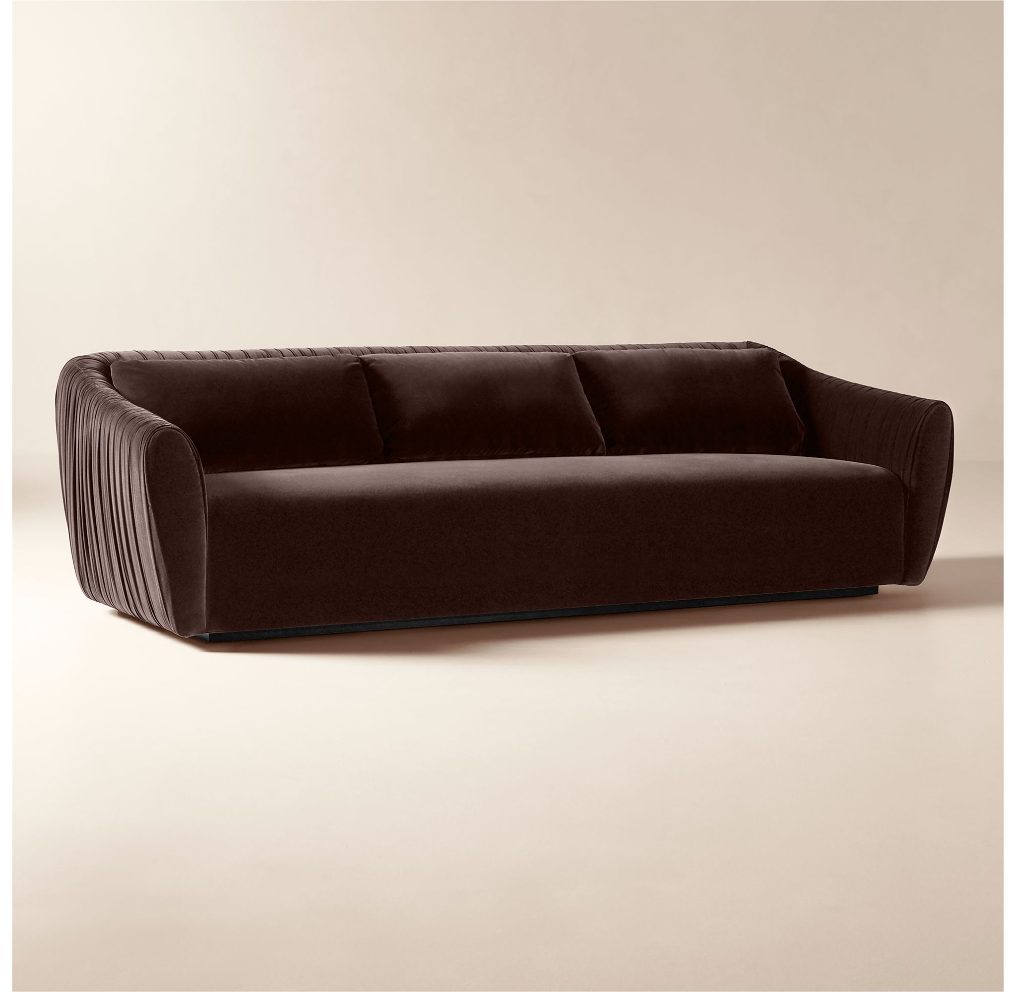 Sofa in dark brown velvet with vertical channeling texture shown from the side.