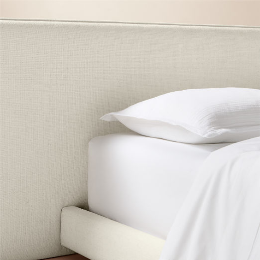 Facade Warm White Upholstered Extended King Bed