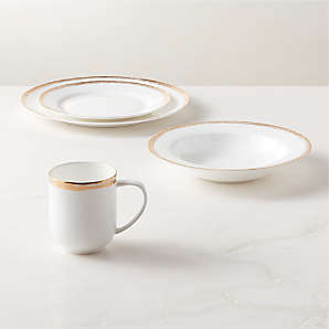 https://cb2.scene7.com/is/image/CB2/IsaWhite4pcPlstWSpBowlSHF23/$web_plp_card_mobile$/230801095827/isa-4-piece-white-and-gold-dinnerware-set-with-soup-bowl.jpg