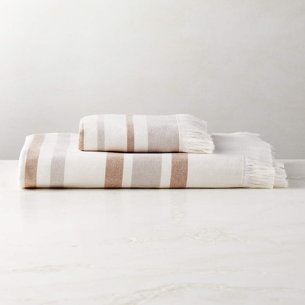 https://cb2.scene7.com/is/image/CB2/KamillaOrgCttnBathTowelGrpFHS23/$web_pdp_main_carousel_sm$/230206152820/kamilla-organic-cotton-striped-copper-bath-towels.jpg