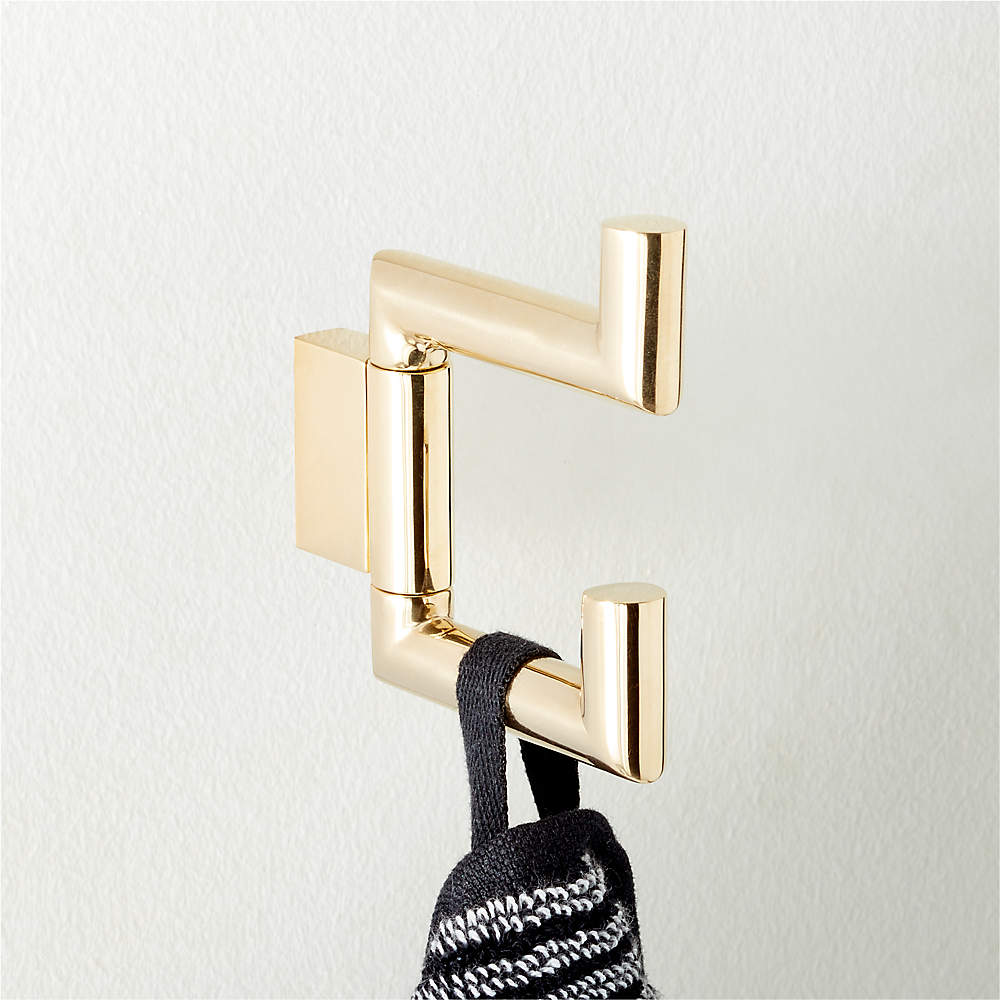 https://cb2.scene7.com/is/image/CB2/KelaSwivelHookPldBrsAVSHF22/$web_pdp_main_carousel_sm$/220606173918/kela-unlacquered-brass-swivel-hook.jpg