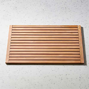 https://cb2.scene7.com/is/image/CB2/LateralNtTkBthmt21p75x32SHF21/$web_plp_card_mobile$/210916111830/lateral-natural-teak-bath-mat-21.75x32.jpg