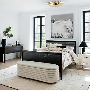 Black bed with white outlet nightstands