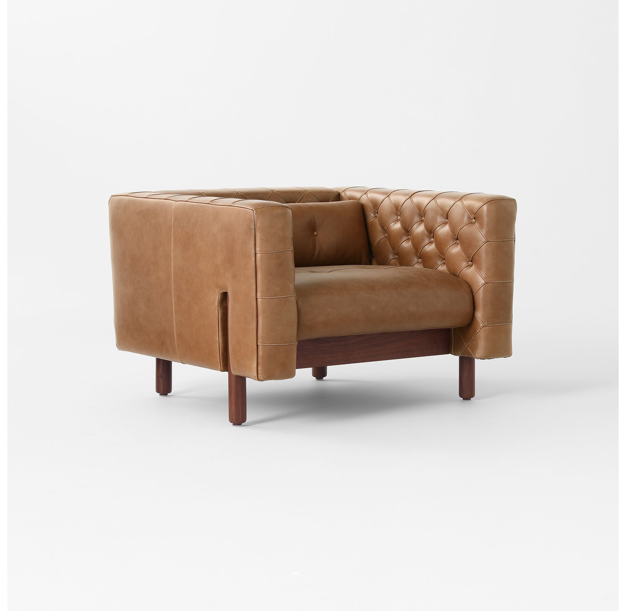 Front view of a tufted saddle leather accent chair.