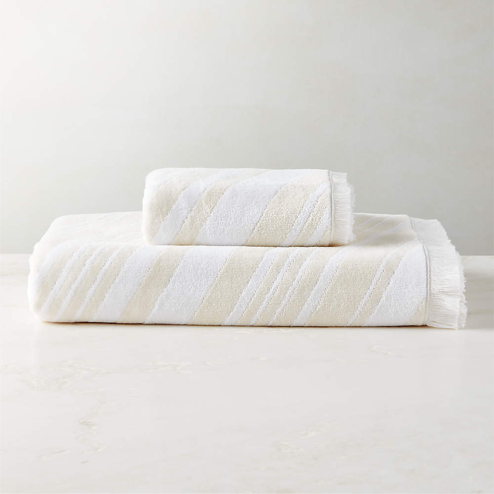 https://cb2.scene7.com/is/image/CB2/OncaWhtIvryOrgCttnCllctnFHF23/$web_pdp_main_carousel_sm$/230605141028/onca-organic-cotton-ivory-and-white-bath-towels.jpg