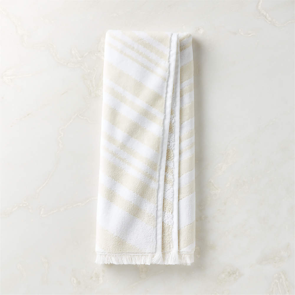 https://cb2.scene7.com/is/image/CB2/OncaWhtIvryOrgCttnHndTwlSHF23/$web_pdp_main_carousel_sm$/230605141019/onca-organic-cotton-ivory-and-white-hand-towel.jpg