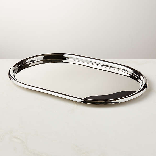 https://cb2.scene7.com/is/image/CB2/PieroOvalSSServingTraySHF22/$web_plp_card_mobile_hires$/240215084929/piero-oval-polished-stainless-steel-serving-tray.jpg
