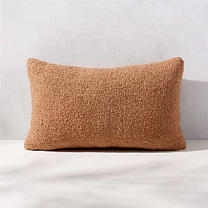 https://cb2.scene7.com/is/image/CB2/SilvesBclCmlODPillow20x12SHS23/$web_plp_card_mobile$/230113113621/silves-camel-brown-boucle-outdoor-throw-pillow-20x12.jpg