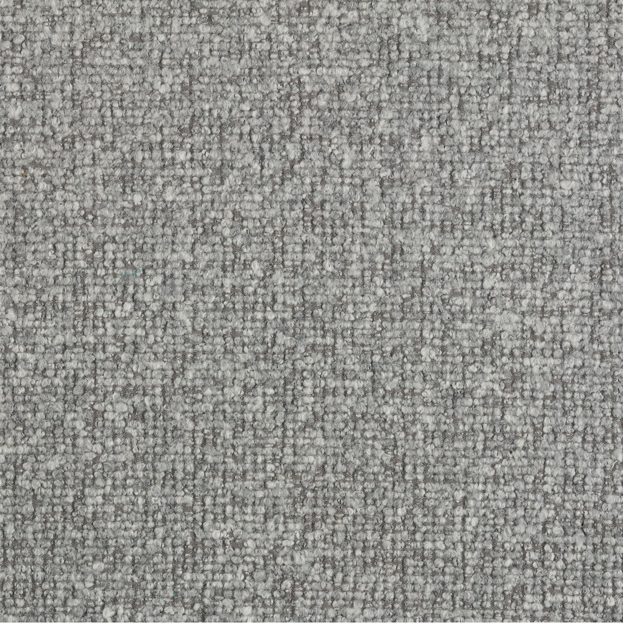 Close-up detail of the textured grey boucle fabric on the ottoman base.