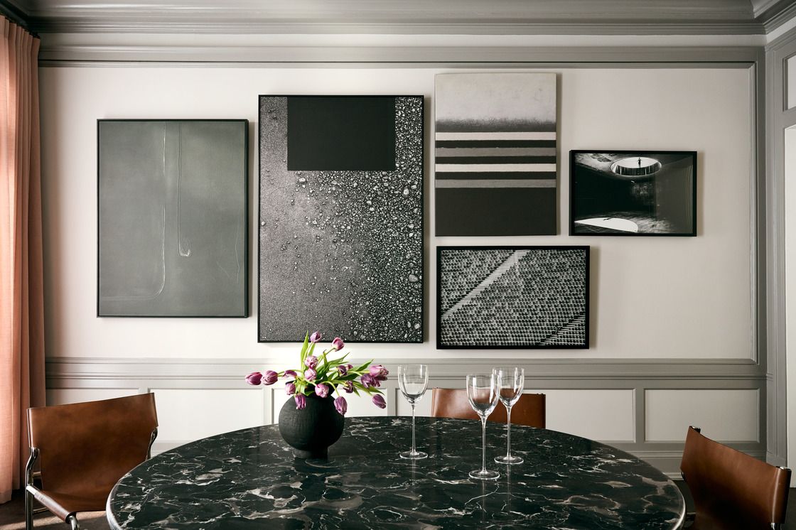 monochromatic artwork gallery wall in a dining room